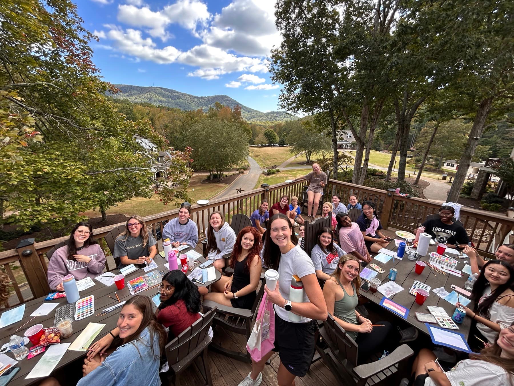 A group of RUF students gathered around an outdoor table at Fall Conference