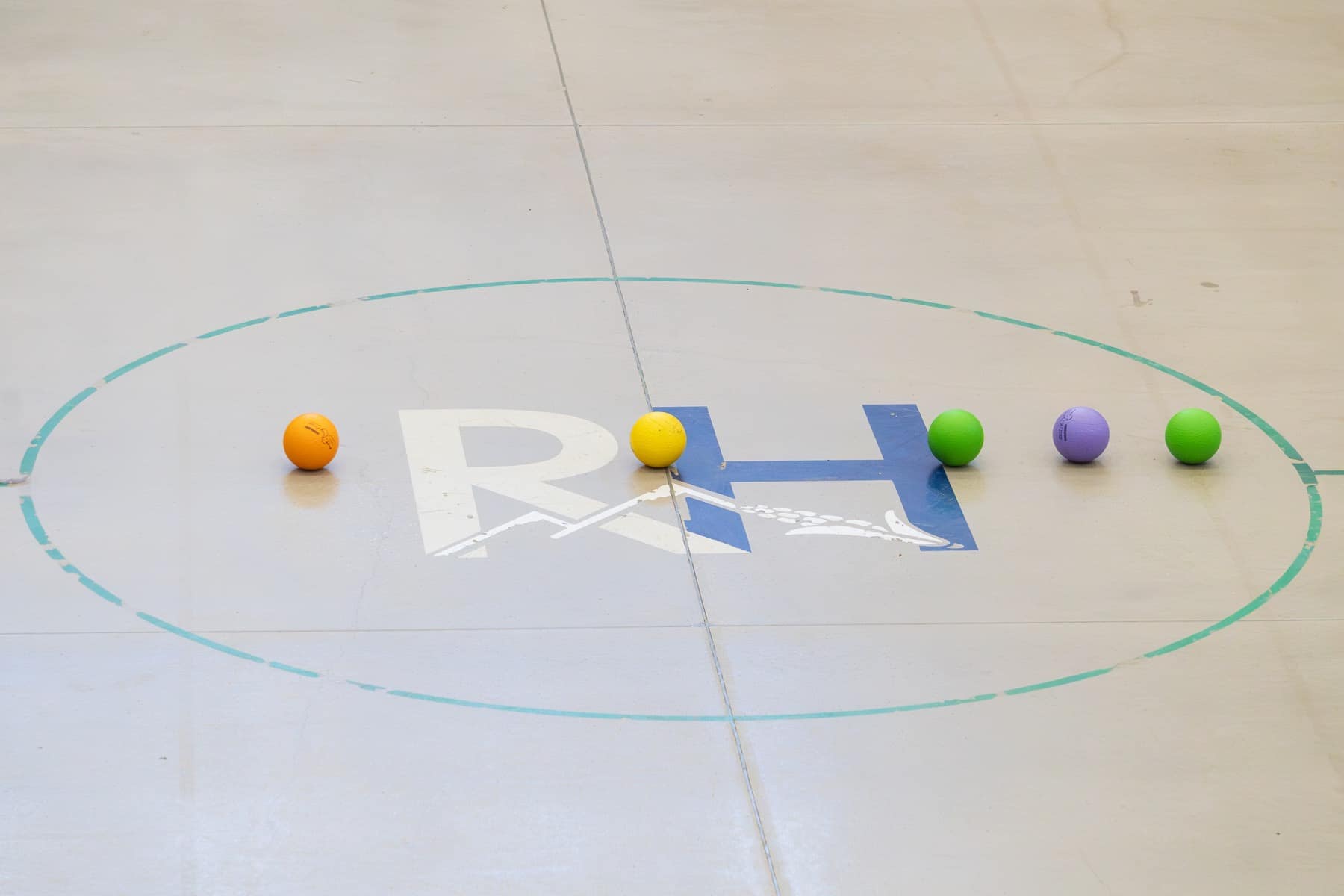 Colorful dodgeballs lined up for a Winter Retreat game