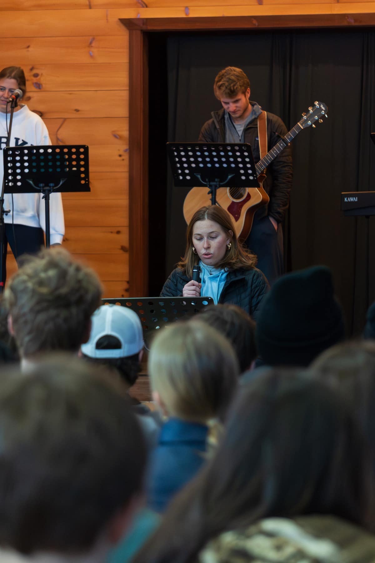 A speaker teaching alongside a guitarist at Winter Retreat
