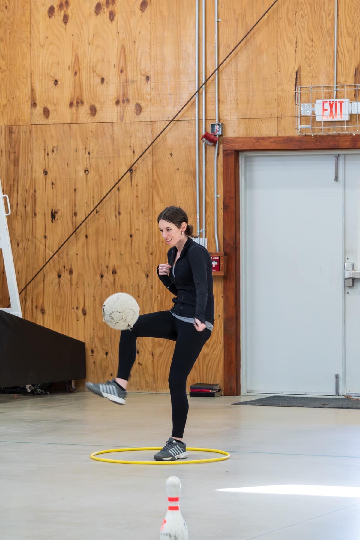 A student kicking a ball during recreation at Winter Retreat