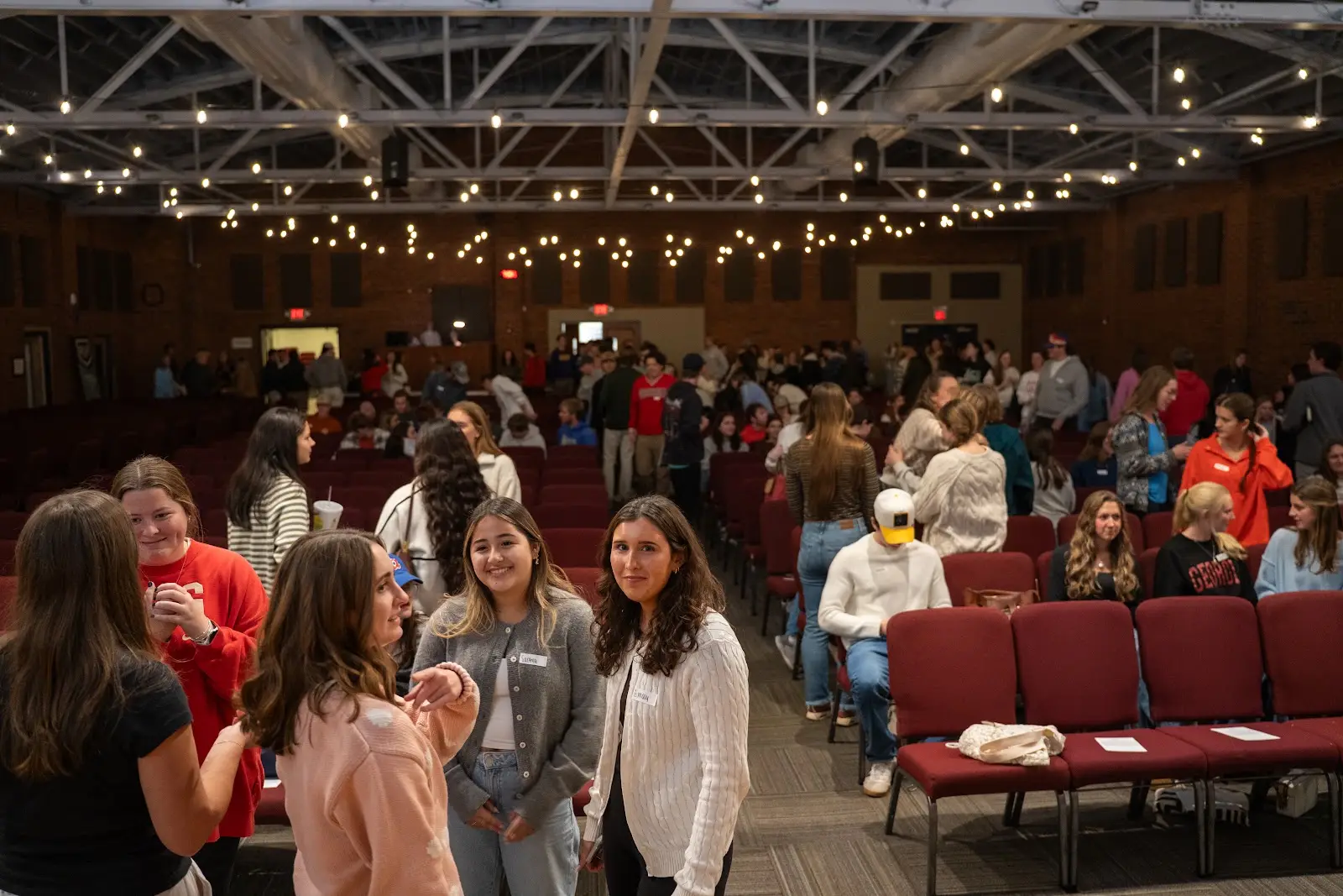 Students meeting and catching up before Large Group begins