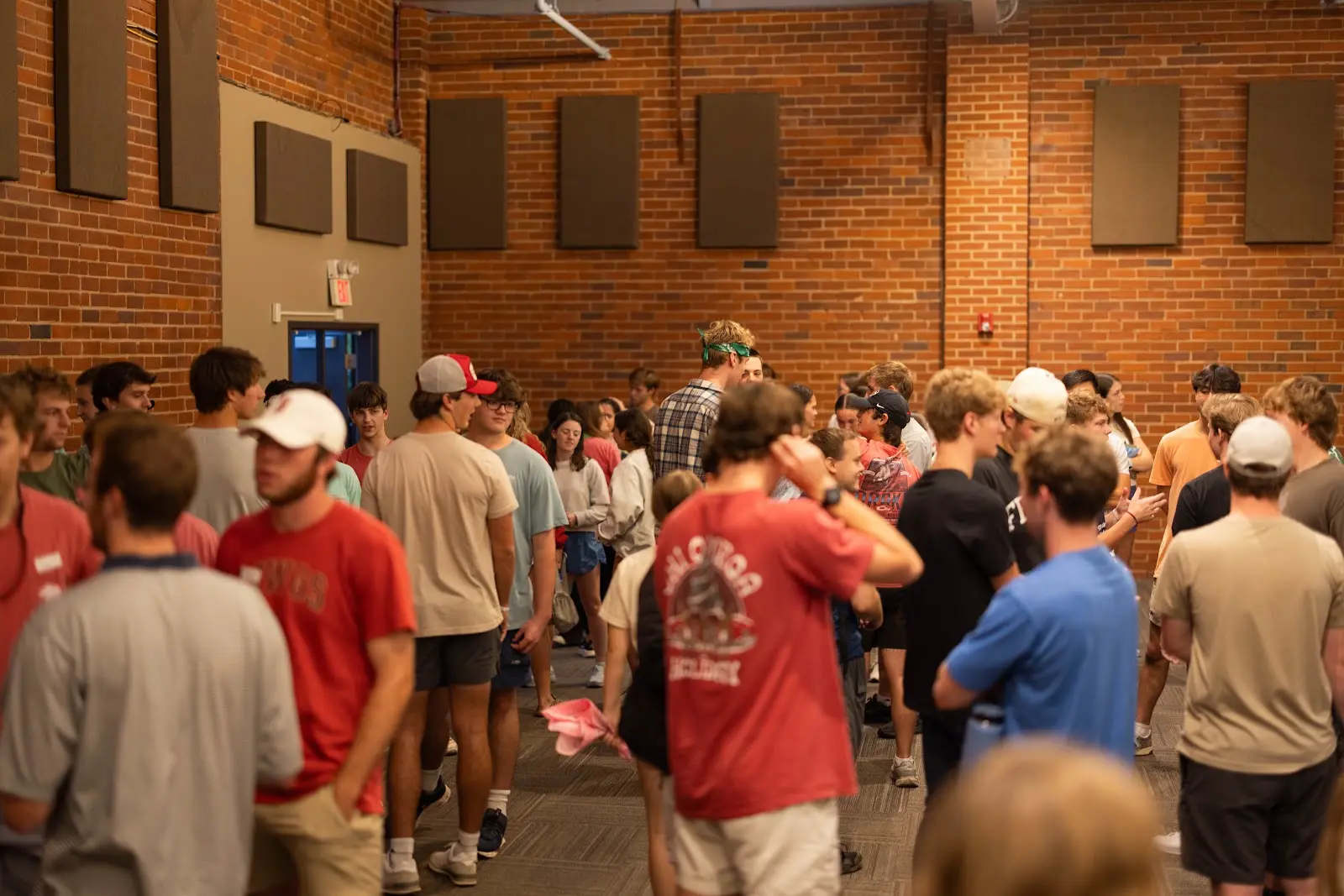 A large crowd of students talking together before RUF Large Group