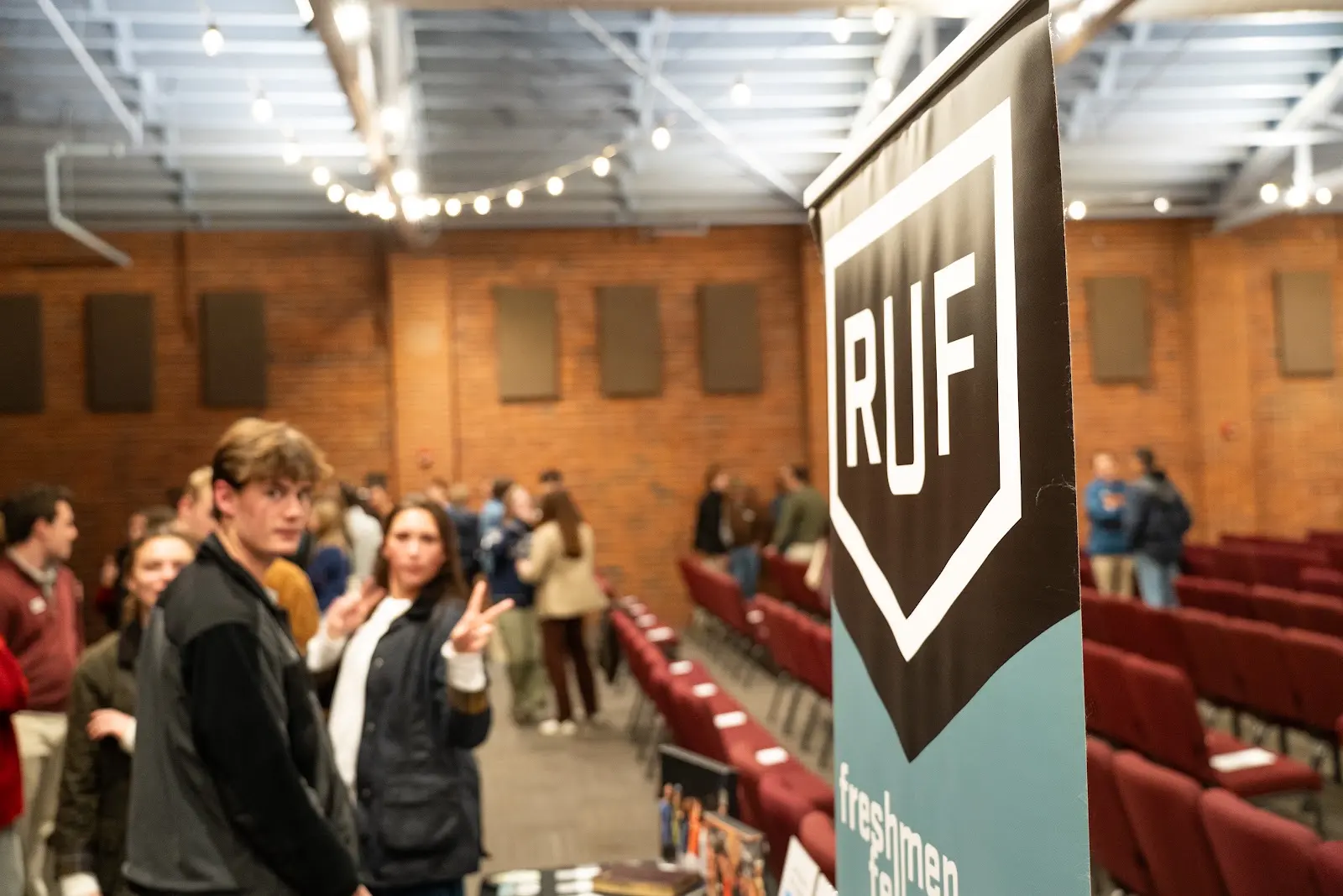 Students gathering around the RUF welcome banner after Large Group