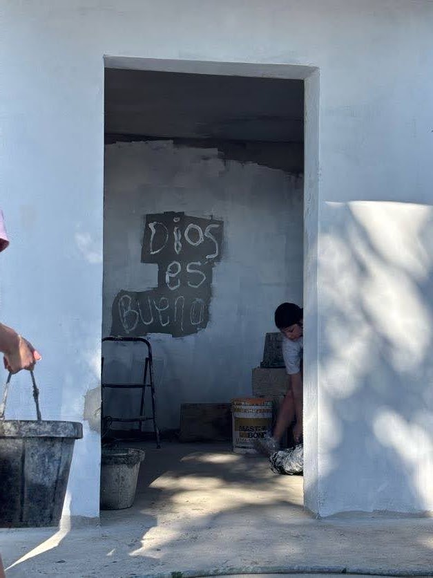 Students working together around a freshly painted doorway