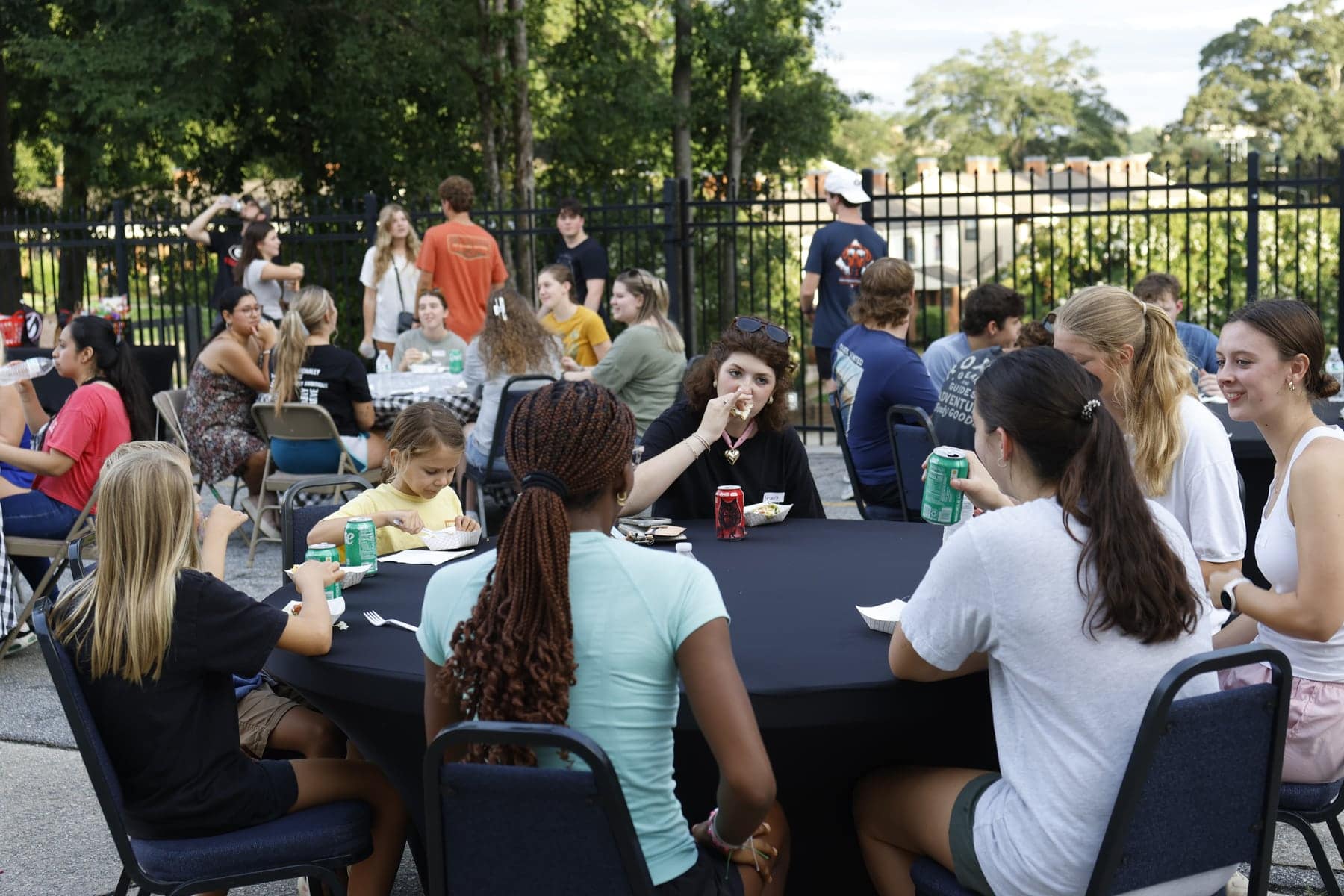 Tables full of students eating and talking outside