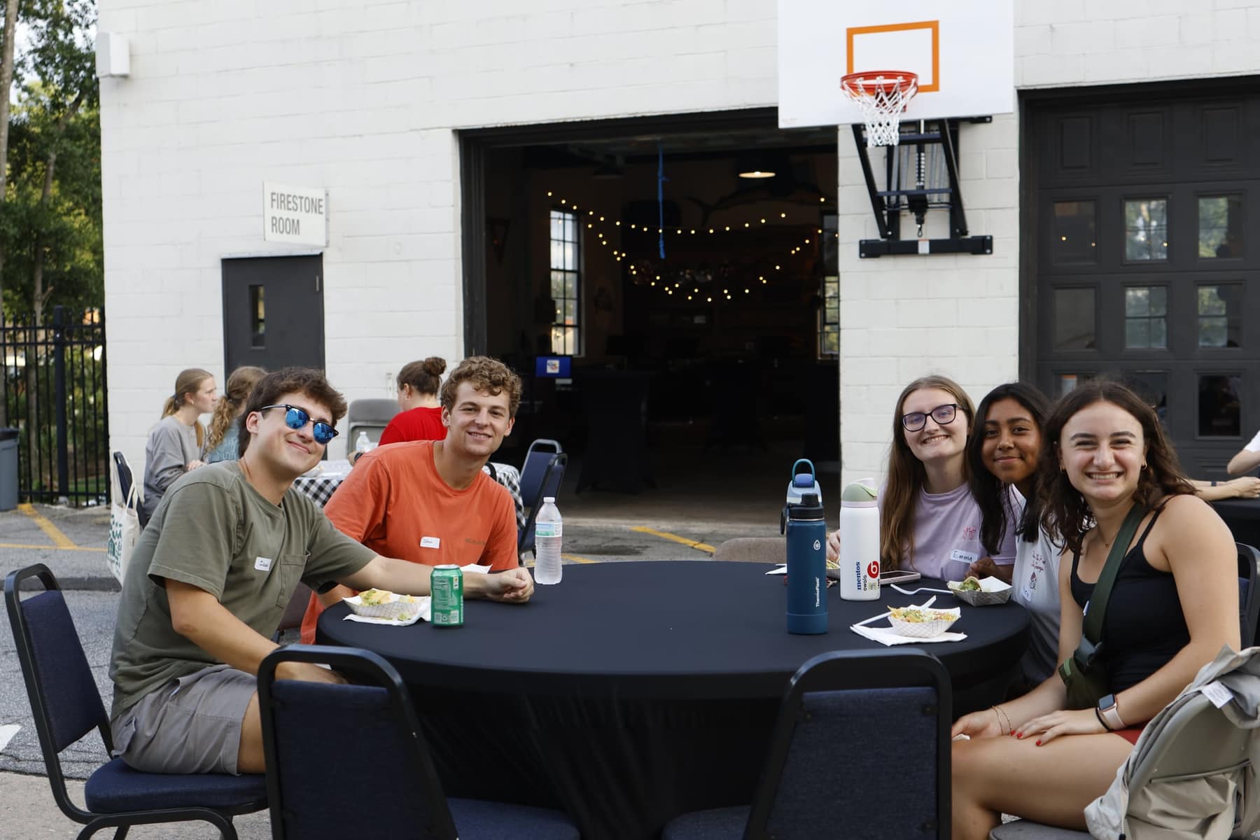 New friends sharing food outside at the Freshman Fellowship Kickoff